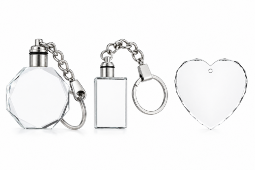 Three crystal keychains with silver metal rings on a white background, including octagon, rectangle, and heart shapes.
